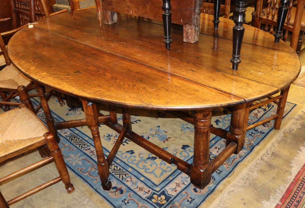 An 18th century style oak wake table, W.210cm, D.150cm extended, H.73cm